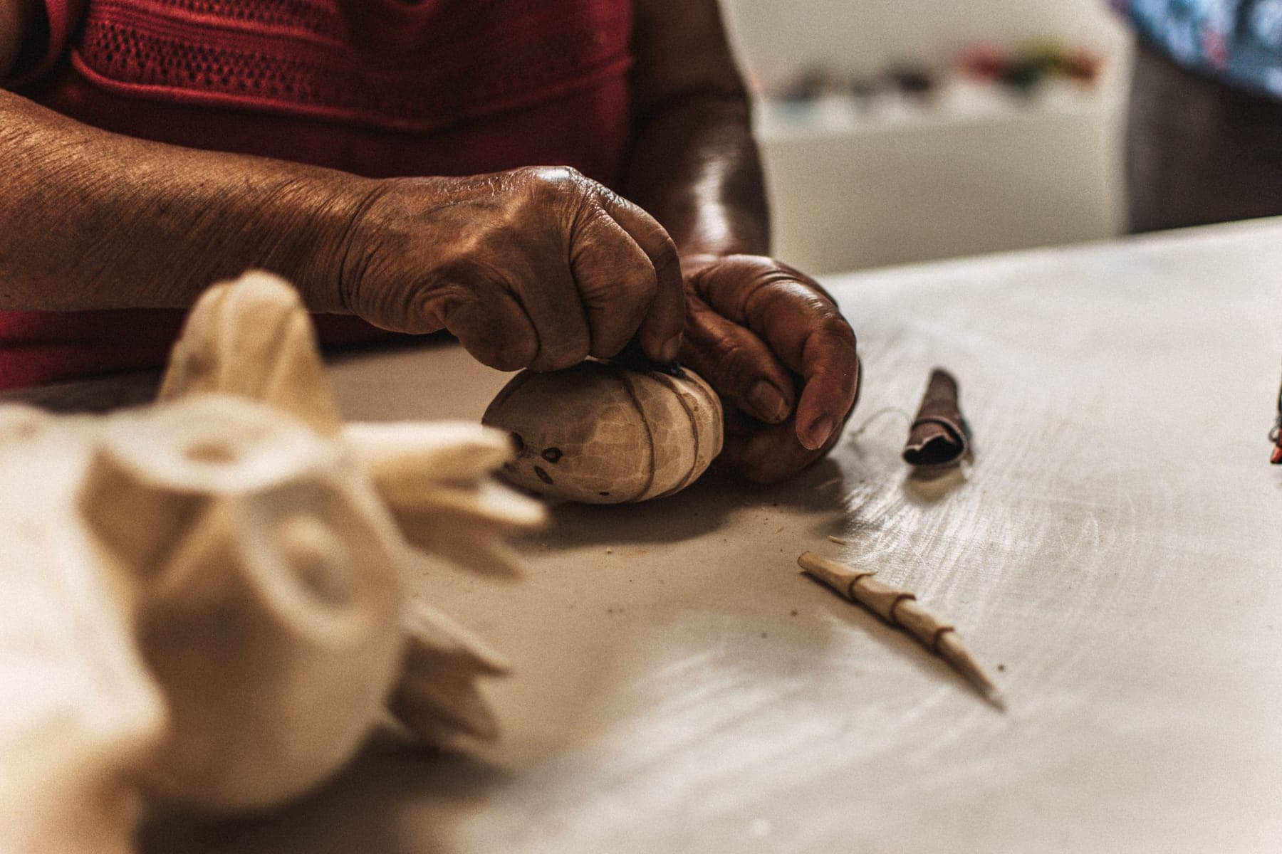 Artisan carving a timber detail by hand
