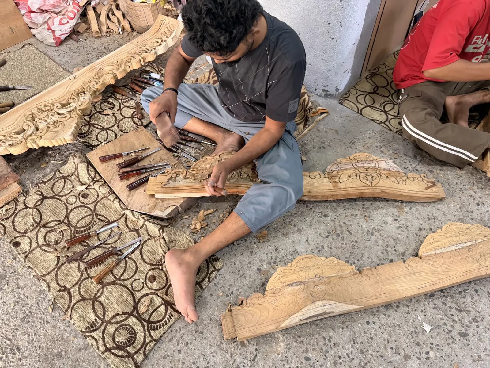 Artisans drafting blueprint stencils and hand-chiseling large architectural relief frieze panels